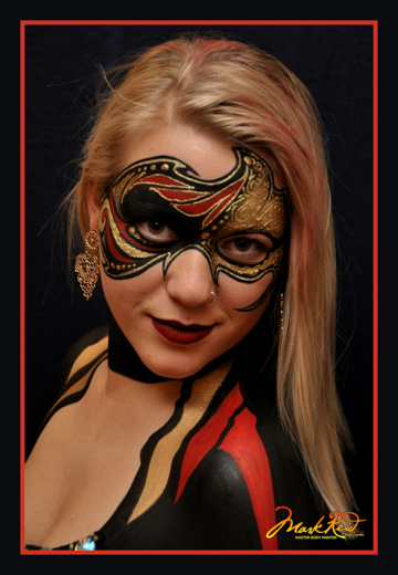 blonde haired woman in painted on mask in red and black